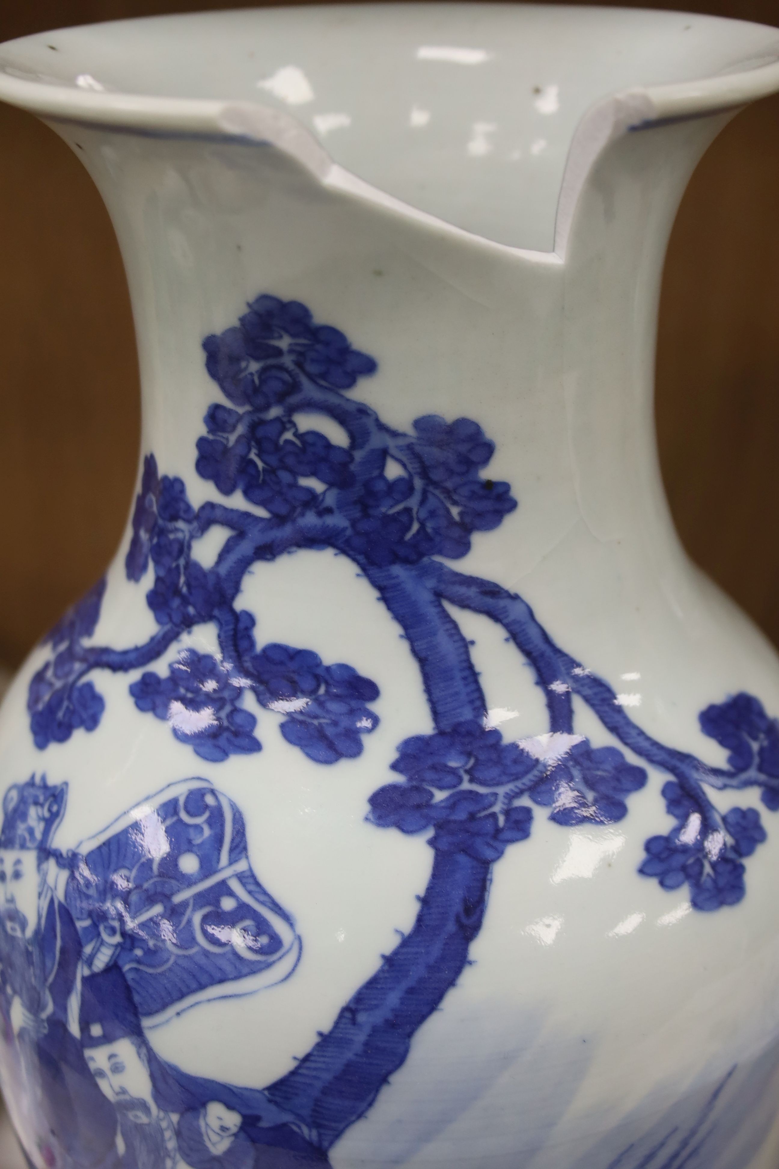 A Chinese blue and white 'Immortals' vase, 18th/19th century, damage, 34.5cm and a Chinese Yongzheng period famille rose ‘phoenix’ vase (reduced in height), 24cm